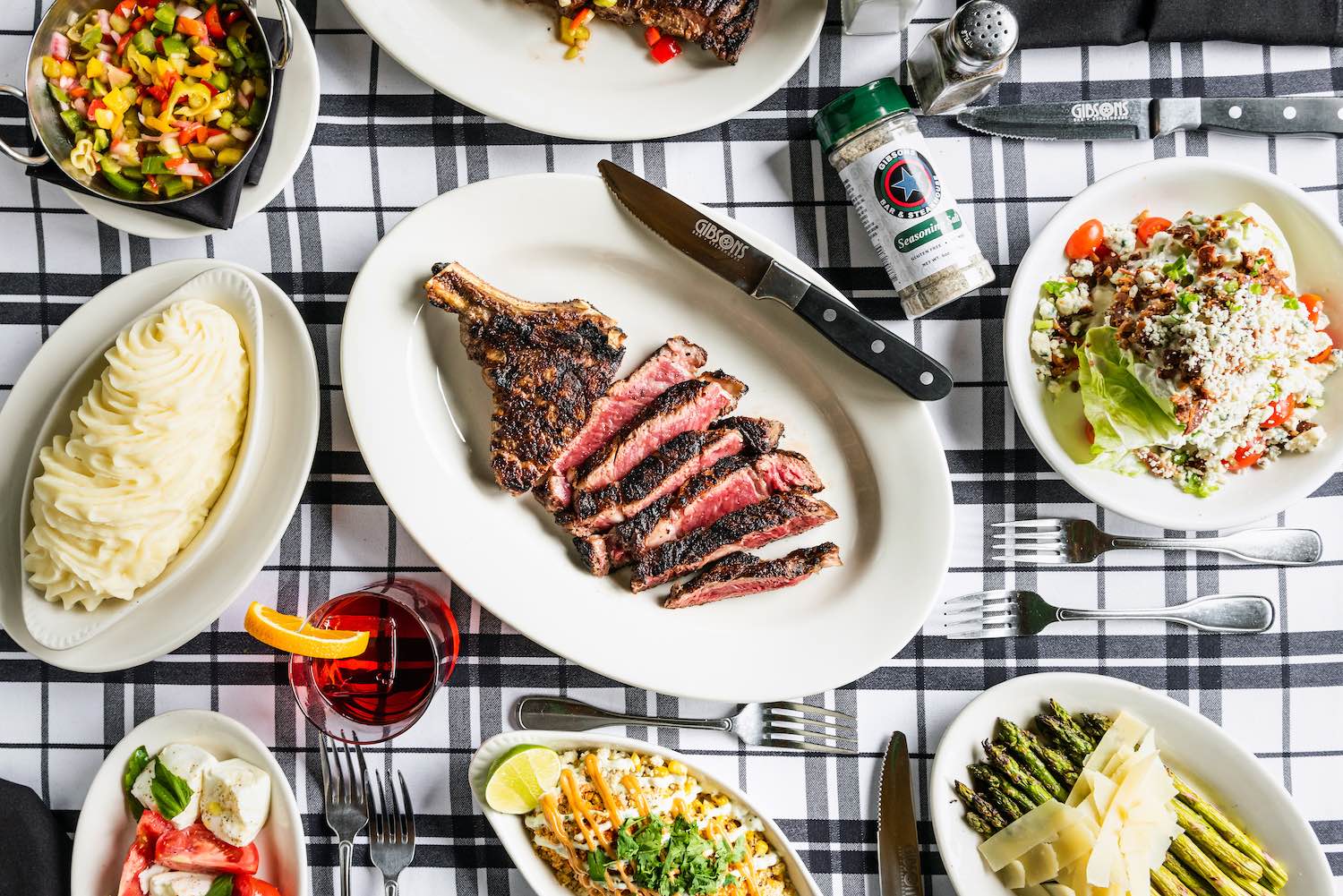 A board with a Gibsons New York Strip steak sliced with Gibsons Seasoning Salt.