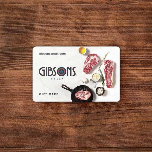 Image of a hand holding a Gibsons gift card